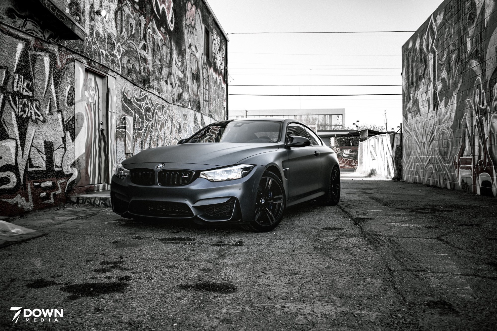 BMW photographed in a graffiti-lined alley