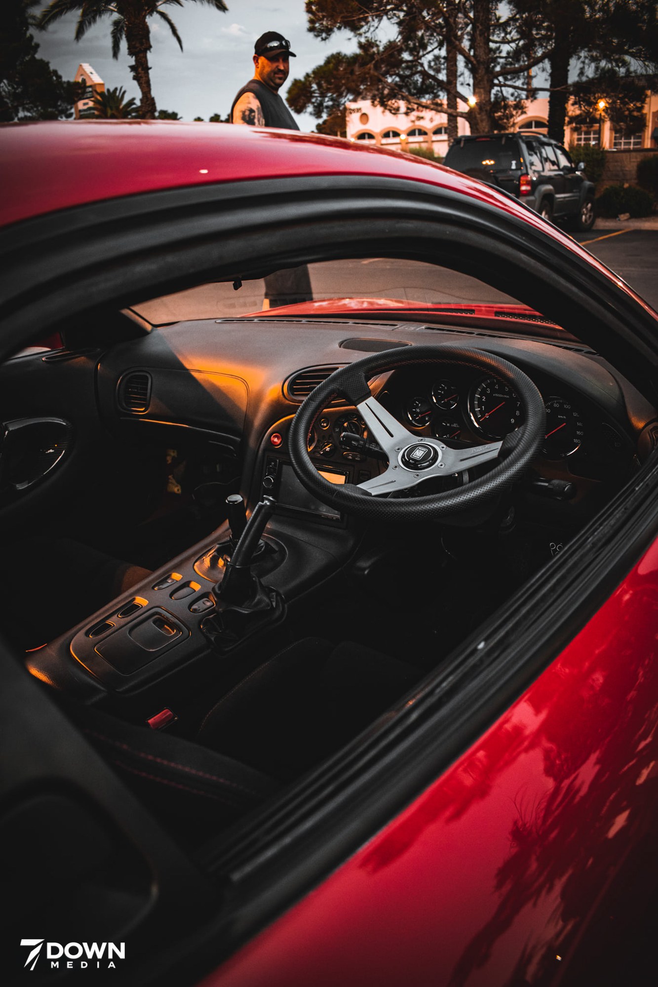 Close-up of the steering wheel and interior of a red sports car